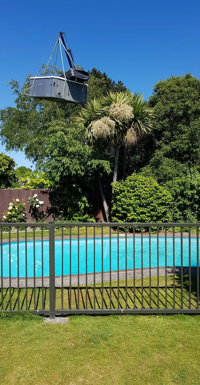 Lifting a spa over the fence into place